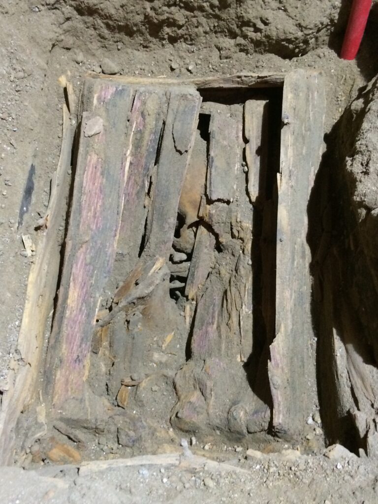 Person buried in a wooden box in the side nave of the church