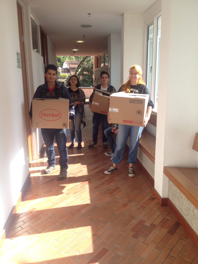 Student members of the project help transport boxes to the laboratory for analysis